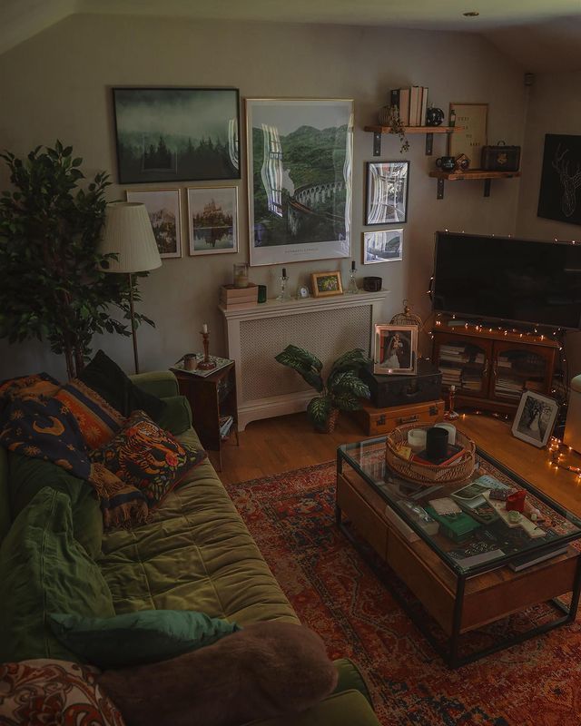 a living room filled with lots of furniture and pictures on the wall above it's fireplace