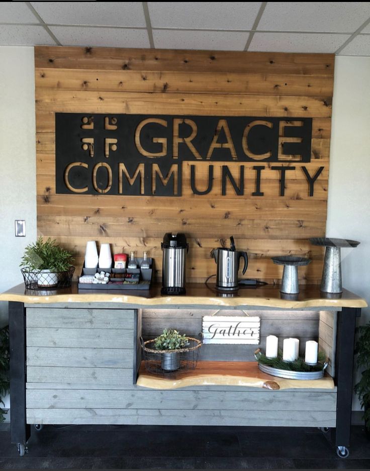 a coffee shop with a sign that says grace community on the wall and plants in front of it