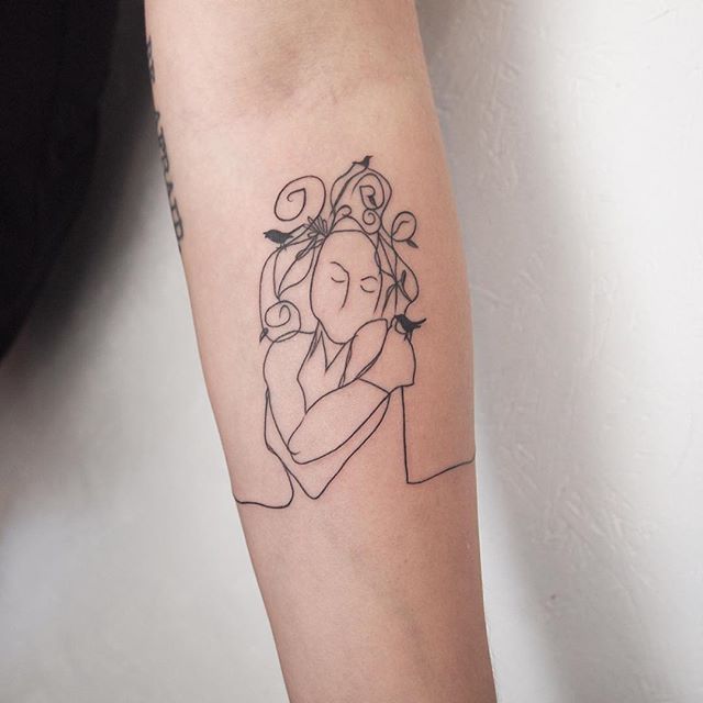 a woman's arm with a tattoo on it