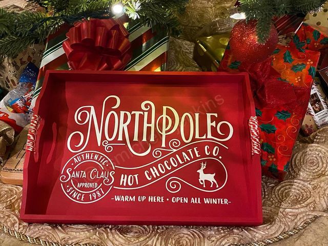 the north pole hot chocolate company sign is surrounded by christmas presents