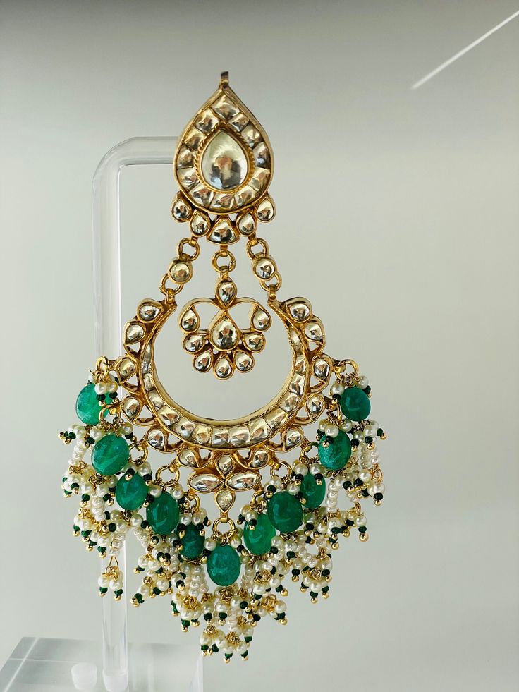 Green Morni long earring will surely make you look like a royalty.A refined handmade jewellery engraved with real kundan stones. Each piece has an intricate bead work to enrich its elegance. Kundan Jewelry For Diwali Celebration, Round Kundan Earrings In Temple Jewelry Style, Cutdana Drop Earrings For Celebration, Festive Temple Jewelry Style Danglers, Festive Temple Jewelry Danglers, Handmade Elegant Chandbali Jhumkas, Handmade Chandbali Elegant Jhumkas, Elegant Handmade Chandbali Jhumkas, Elegant Handmade Festive Chandbalis