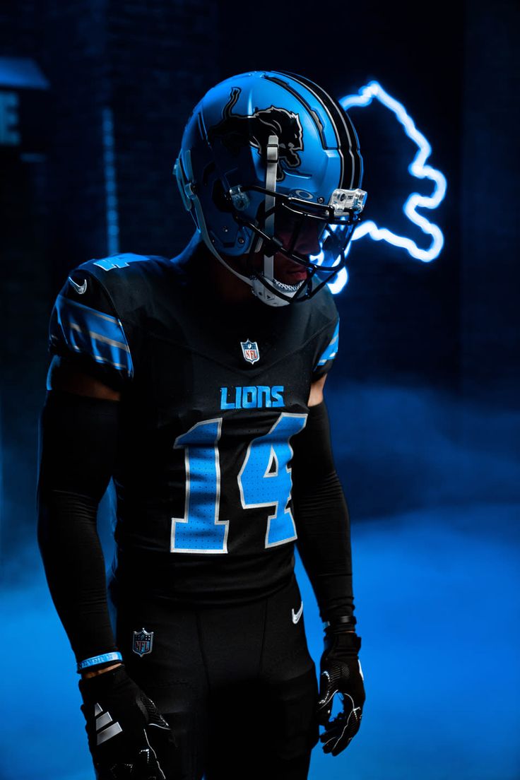 a football player wearing a black uniform and blue helmet with his hands in his pockets