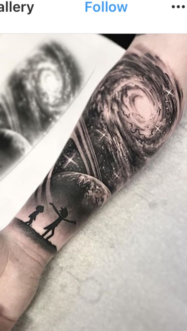 a man's arm is covered in black and white ink with an image of two people