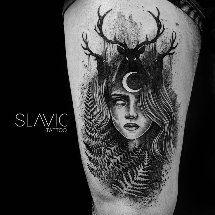 a woman with deer horns and moon on her head is depicted in this black and white tattoo