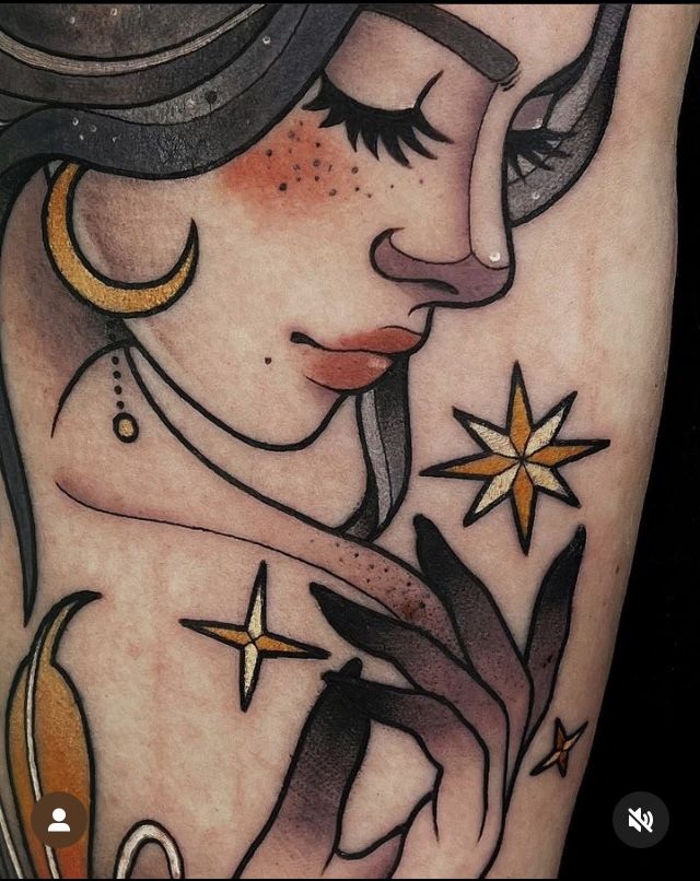 a woman's face with stars and moon tattoos on her arm