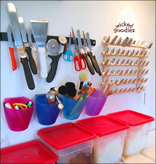 several bins and utensils are hanging on the wall