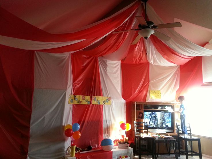 the room is decorated with red, white and blue draping on the ceiling