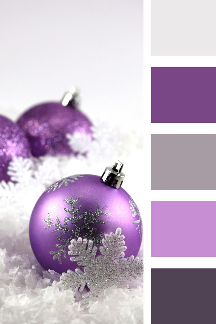 two purple christmas ornaments sitting on top of snow covered ground with white and gray colors