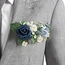 a man wearing a gray suit and blue flower boutonniere on his lapel