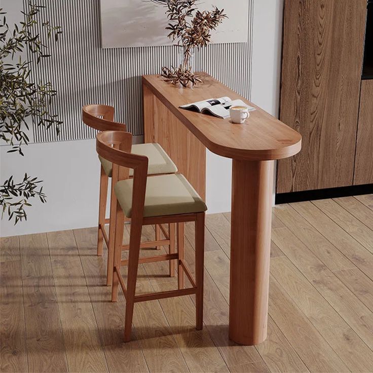 a wooden table with two stools next to it and a painting on the wall