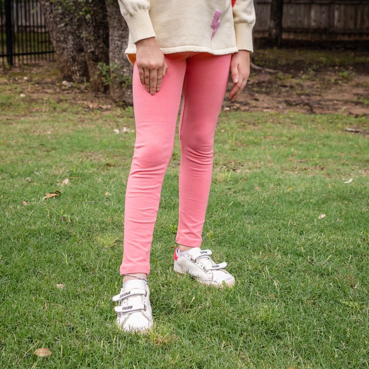 Our coral knit leggings feature an elastic waistband. Pairs with our Hope Sweatshirt in Coral Hearts, Clara Tunic Sweater in Bolts, and Finley Sweatshirt in Stars Run true to size. Models are wearing size 7 and 8. This garment is made with pre-shrunk lycra cotton knit. Don't forget the matching coral knot headband with pom poms. Coral Girls, Fall Activewear, Patriotic Accessories, Patriotic Dresses, Fall Outerwear, Fall Clothing, Solid Leggings, Boys Swim, Bubble Romper