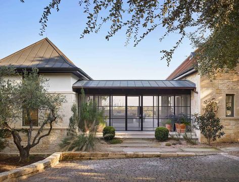 the front entrance to a modern home with stone steps leading up to it's entry