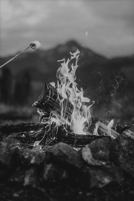 a person standing in front of a fire with a light on it's head