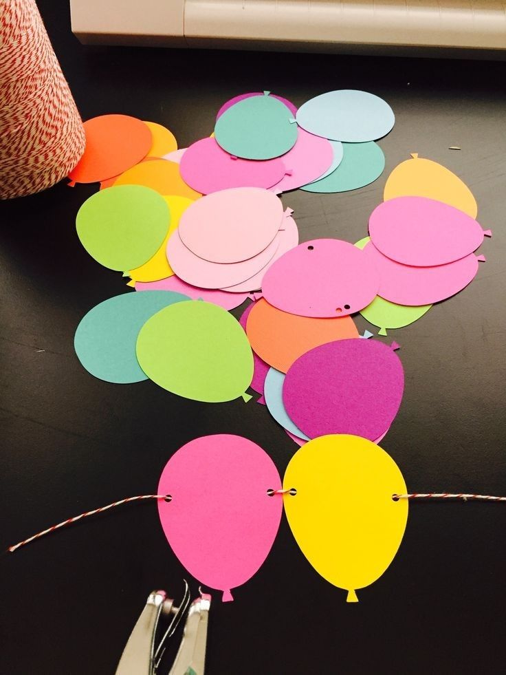 several different colored paper balloons on a table