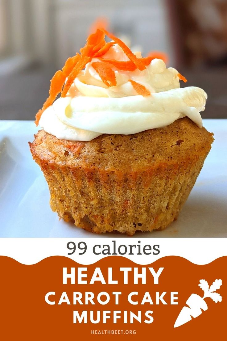 healthy carrot cake muffins with white frosting and carrots on the top