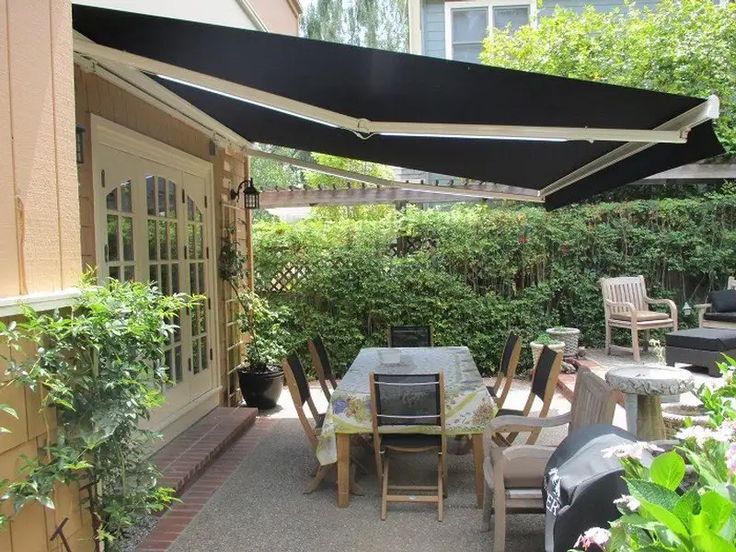 an outdoor dining area with table and chairs