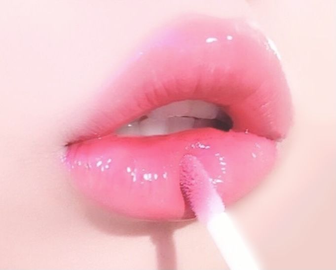 a woman's lips with pink liquid on them