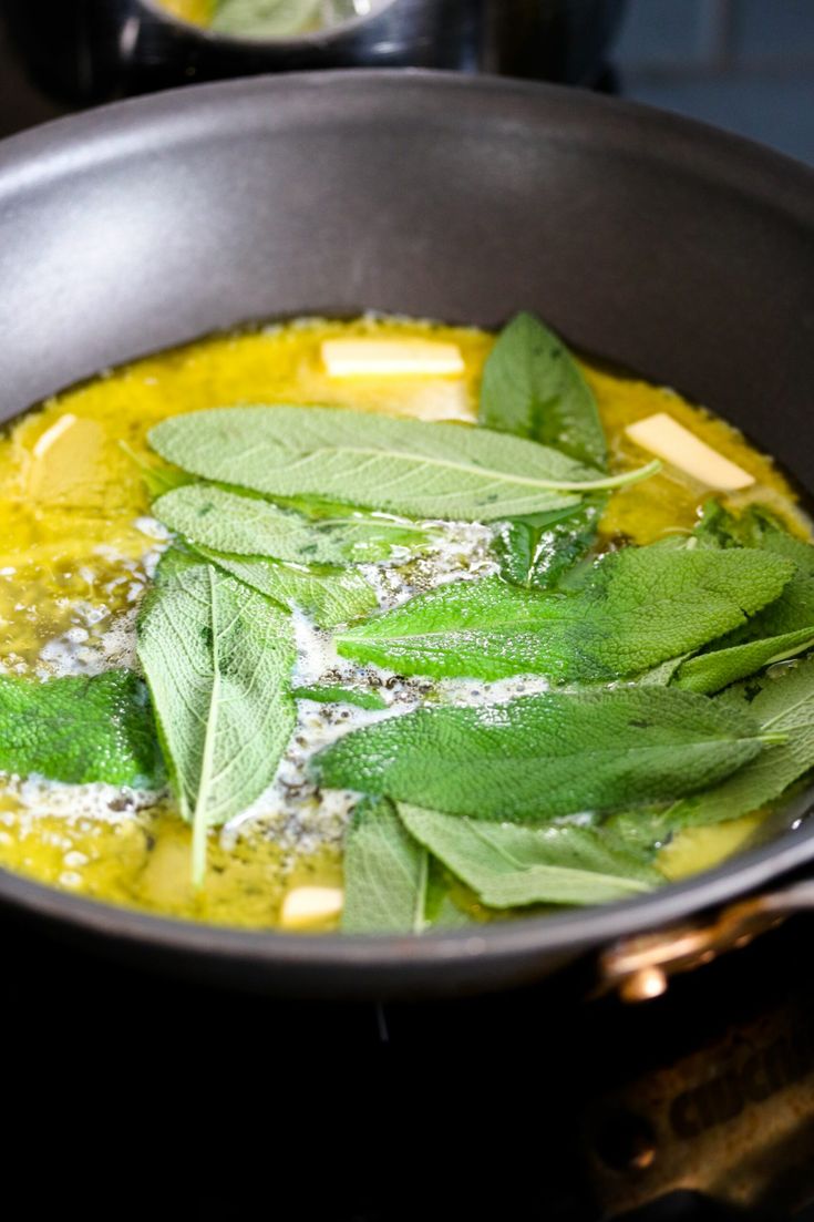 a pan filled with green vegetables on top of a stove