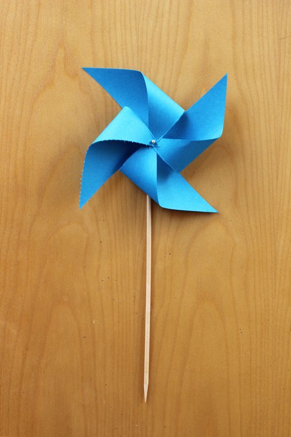 a blue pinwheel sitting on top of a wooden table