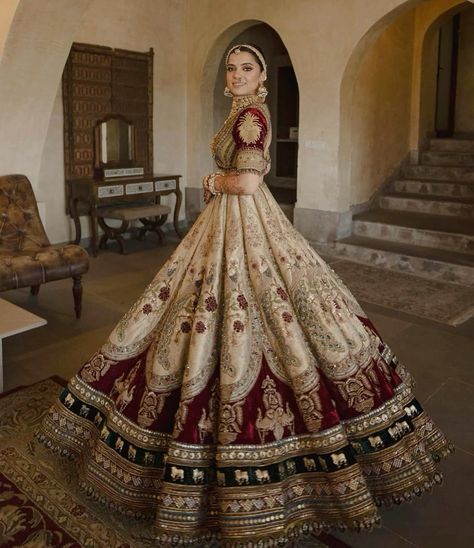 a woman in a red and gold wedding dress