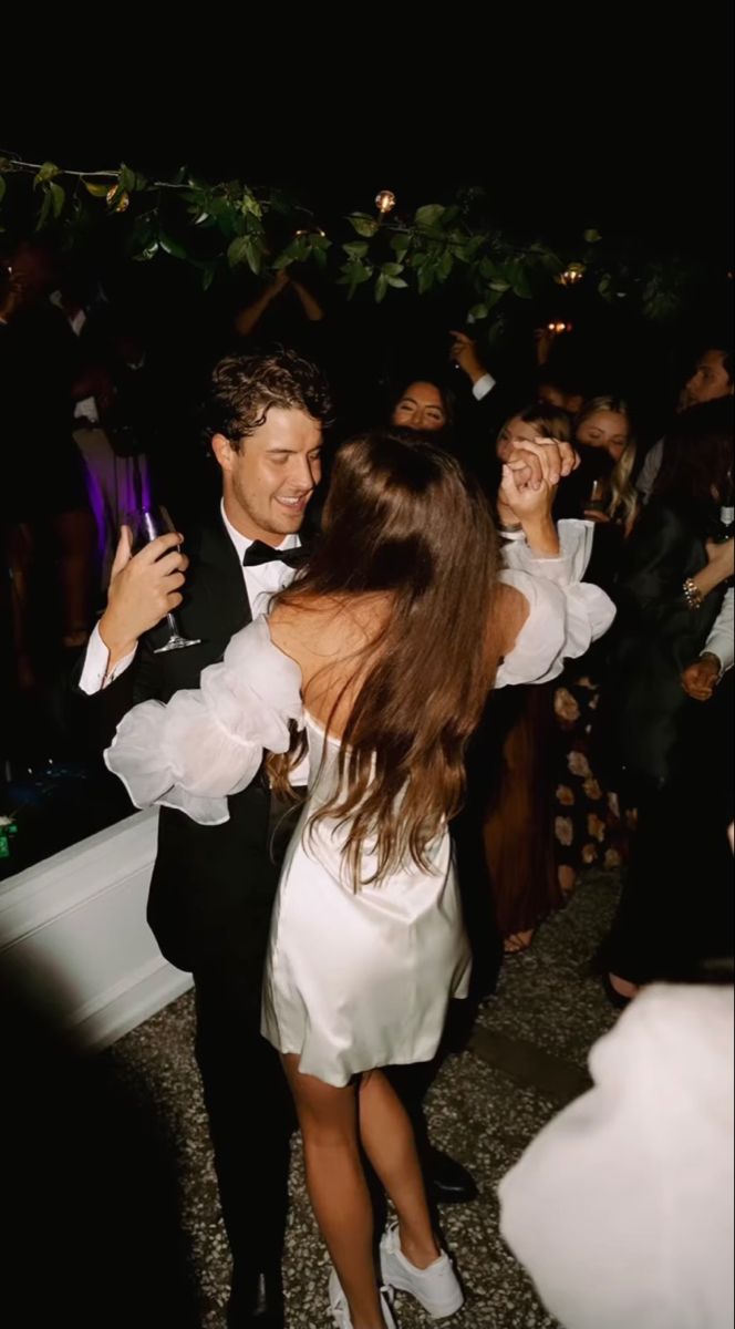 two people in formal wear dancing at a party