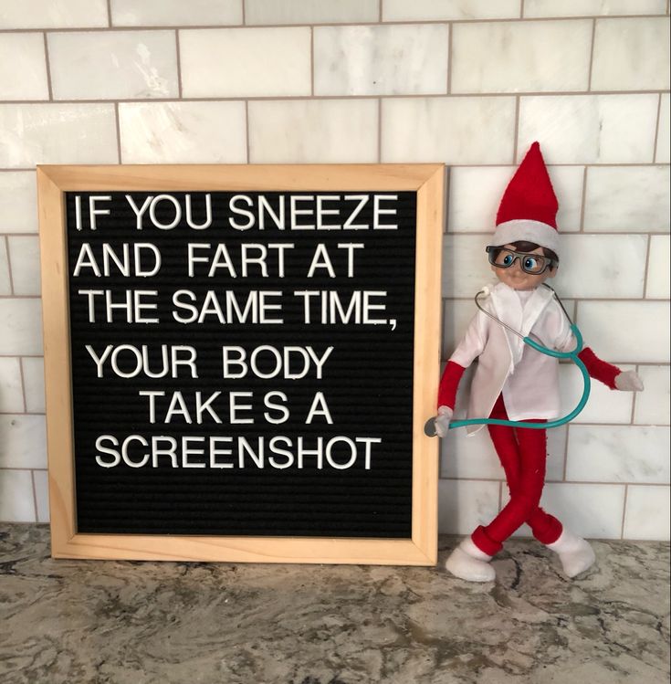 an elf is standing next to a sign that says if you sneeze and far at the same time, your body takes a screenshot