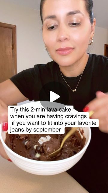 a woman is holding a bowl of ice cream and eating it with a spoon in her hand