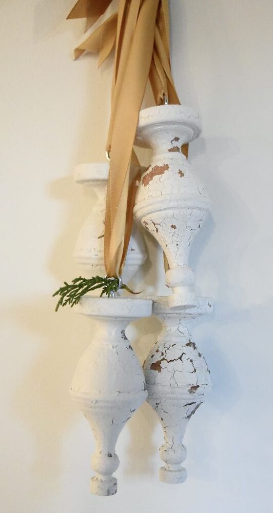 two white vases are stacked on top of each other and tied to the wall