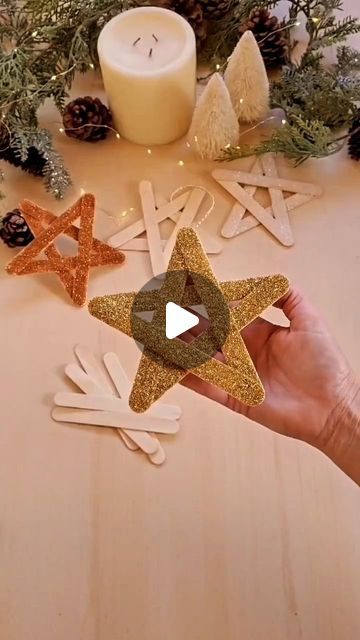 someone is holding up some star decorations