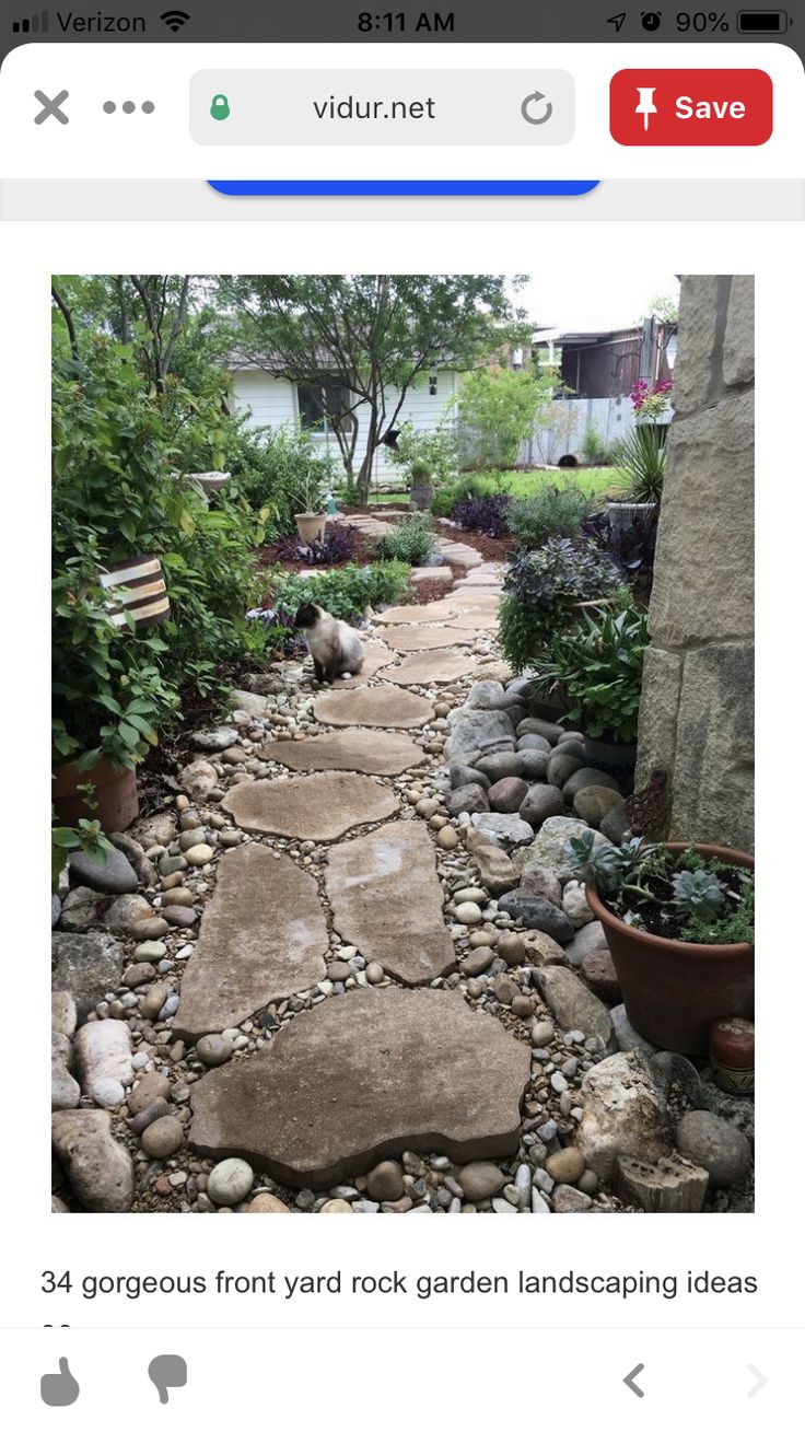 a stone path in the middle of a garden