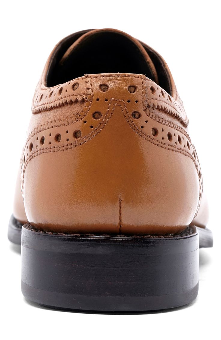 Brogue accents add charm to a stylish oxford topped with fine-grain leather while Goodyear welts ensure lasting durability. Leather upper and lining/rubber sole Imported Asian Owned/Founded Classic Wingtip Oxford For Business, Classic Wingtip Oxford Shoes For Business, Leather Oxford Shoes With Almond Toe, Classic Oxford Shoes With Brogue Detailing, Leather Oxford Shoes With Almond Toe For Derby, Business Oxfords With Perforated Plain Toe, Classic Brogue Oxford Shoes For Semi-formal Occasions, Business Oxfords With Perforated Toe Box, Classic Leather Brogue Shoes With Almond Toe