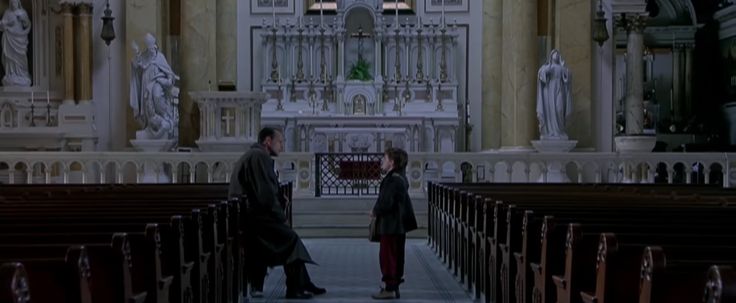 two people standing in the aisle of a church