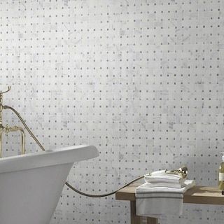 a white bath tub sitting next to a wooden table