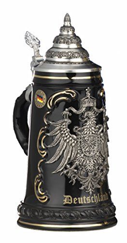 a black and silver beer mug with an eagle on the front is sitting in front of a white background