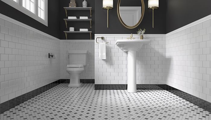 a bathroom with black and white tile flooring, two sinks and a mirror on the wall