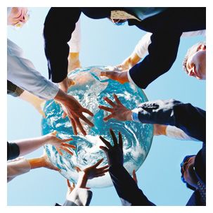 several people holding their hands together in the middle of a glass bowl that is filled with water