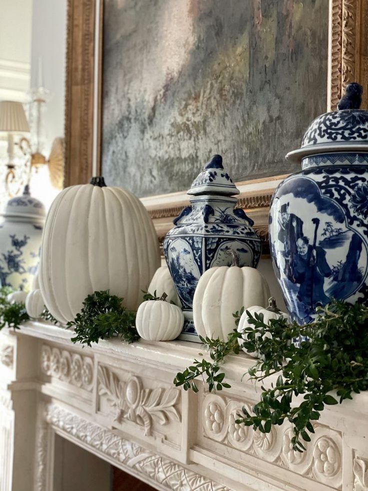 some blue and white vases are sitting on a mantle