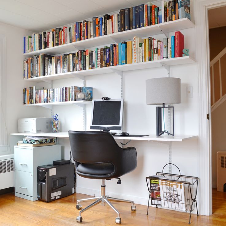 a home office with bookshelves, desk and chair