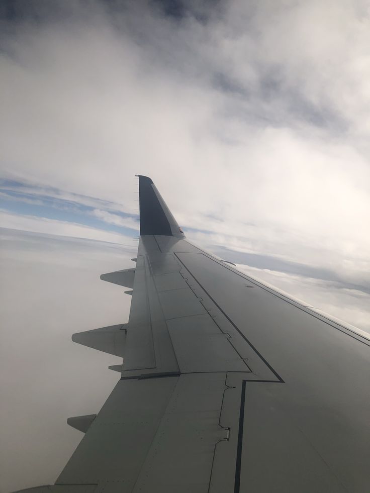 the wing of an airplane flying in the sky