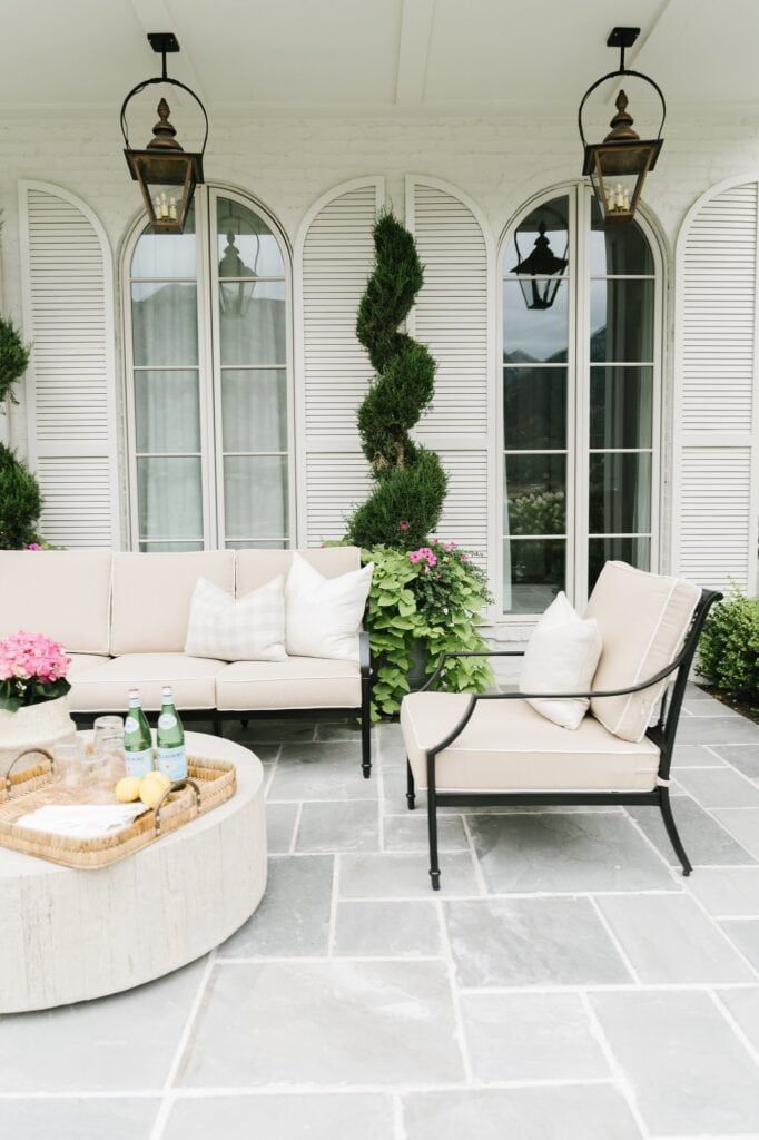 an outdoor living area with couches and tables