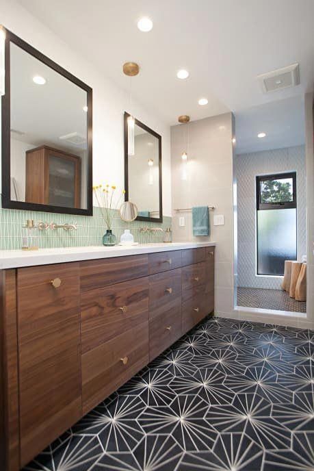 a large bathroom with two sinks and mirrors on the wall next to a shower stall