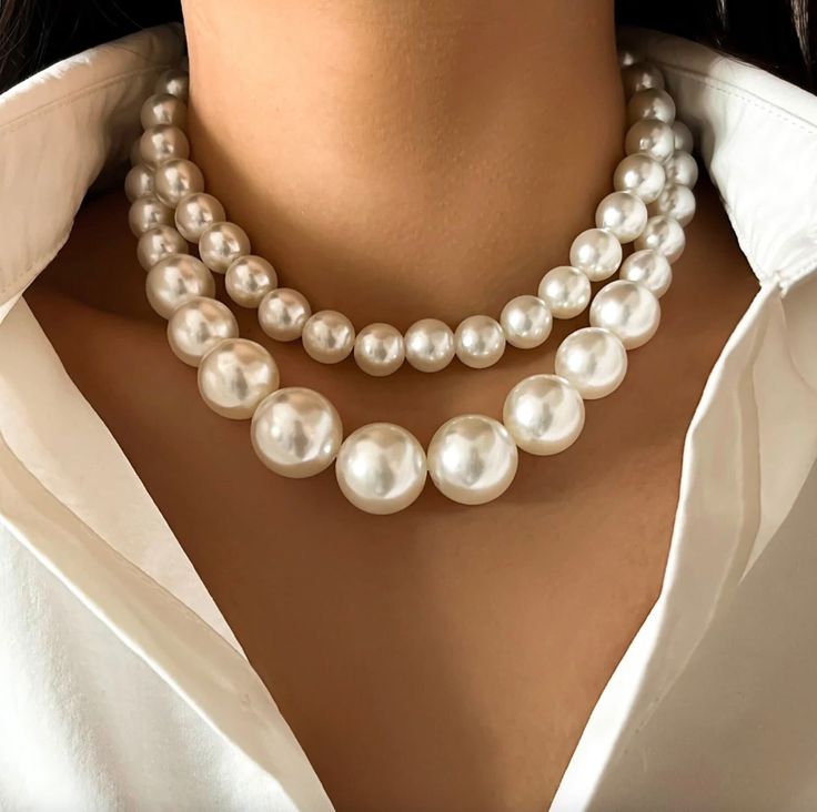 The pearl beaded choker necklace collar is an elegant and timeless accessory designed to accentuate the neckline. Adorned with lustrous, creamy-white pearl beads arranged in multiple rows, it exudes sophistication and grace. The collar-style design sits snugly around the neck, framing the collarbone and adding a touch of vintage charm to any outfit. Equipped with an adjustable closure for a customized fit, this versatile accessory can be worn with both formal and casual attire, making it a must- Luxury Elegant Pearl Embellished Choker, Luxury Formal Pearl Necklace, Luxury Feminine Pearl White Jewelry, Luxury White Gold Necklaces With Pearl Embellishments, Luxury White Necklaces For Festive Occasion, Luxury Pearl White Necklace, Luxury Elegant White Gold Pearl Necklace, Luxury White Choker For Formal Occasions, Luxury Pearl White Choker Jewelry