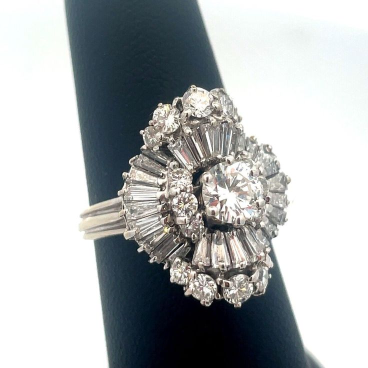 * Estate 14k White Gold Round Diamond Center Waterfall Wave Accented Cocktail Ring * Ring Size: 7.0 * Top Of Ring Measures: 7/8" X 5/8" * Height: 1/2" * Band Width: 2.05 Mm * Round Diamond Measures Approximately 5.6 Mm * Twenty-Six Baguette Diamonds Measure Approximately 3.0 Mm X 1.3 Mm X .95 Mm Each * Two Round Diamonds Measure Approximately 3.1 Mm Each * Six Round Diamonds Measure Approximately 2.25 Mm Each * Eight Round Diamonds Measure Approximately 1.6 Mm Each * Ring Weight: 6.3 Tgw * Marke Antique Jewelry Rings, Baguette Diamonds, Baguette Diamond, Ring Ring, Cocktail Ring, Womens Jewelry Rings, Cocktail Rings, Rings Statement, Vintage Watches