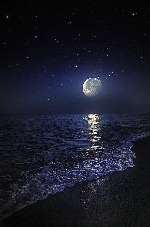 the moon is shining brightly over the water at night on the ocean shore with waves coming in