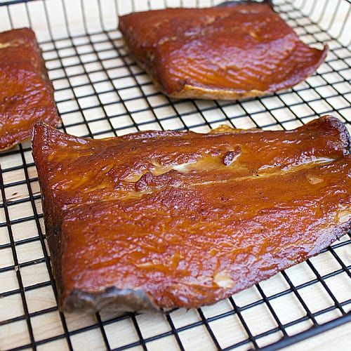 three pieces of meat sitting on top of a cooling rack