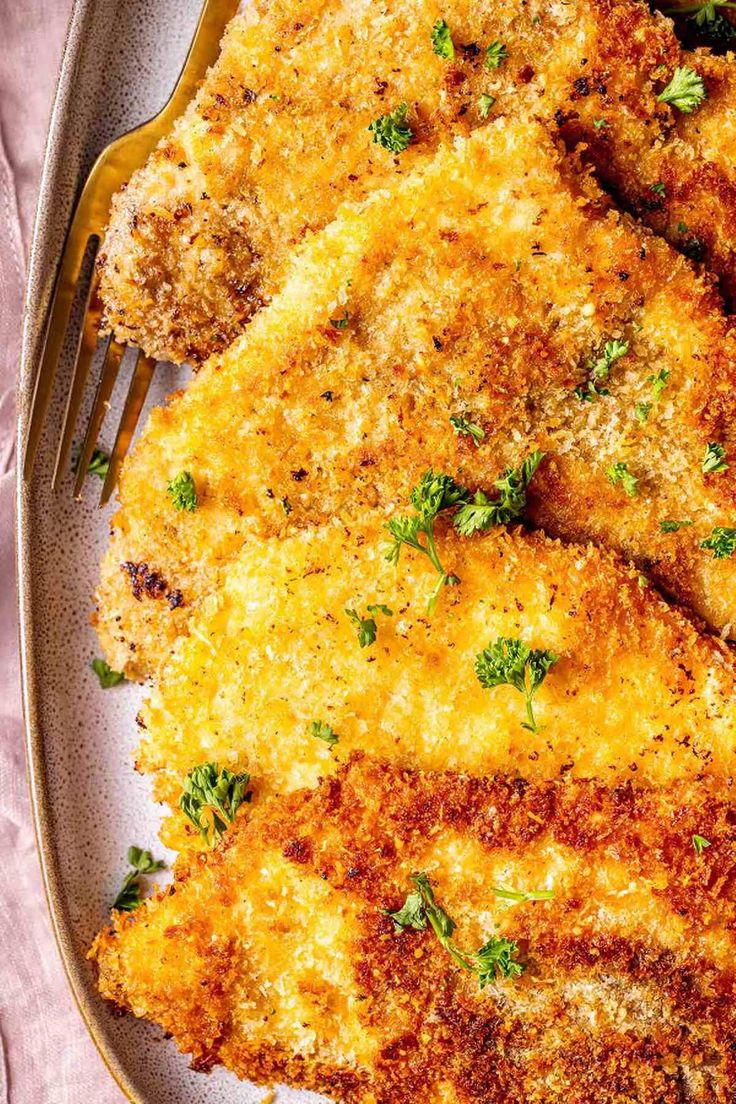 some fried food on a plate with a fork