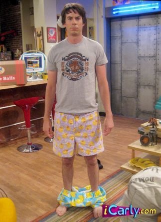 the young man is standing in his pajamas on the set of tv show big brother