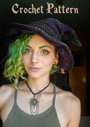 a woman with green hair wearing a black hat