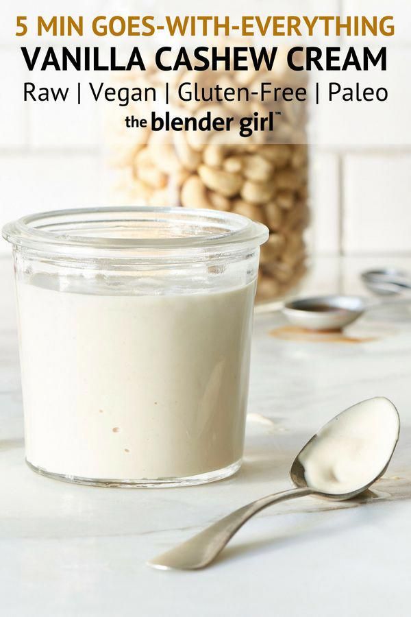 vanilla cashew cream in a glass jar with spoons next to it on a white counter