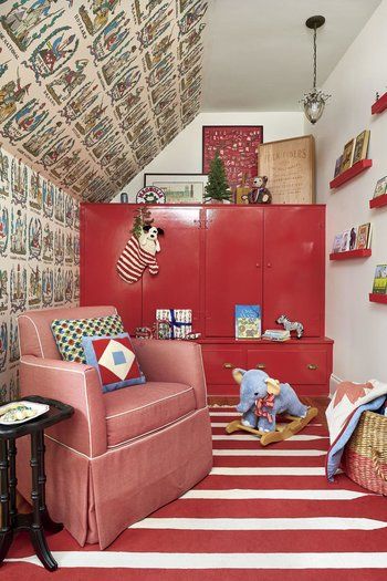 a child's room with red furniture and wallpapered walls in the ceiling